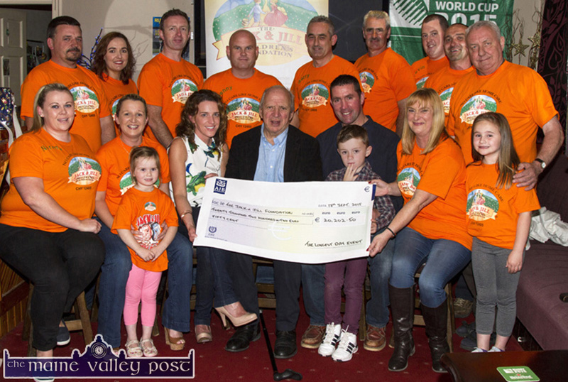 Jonathan Irwin (seated centre) pictured receiving a cheque for €20,202.50 from the organisers and participants of The Longest Day Charity event. Included are, front: Norma Nolan-Moran, Eileen and Abbie Greaney, Fiona Clifford, Mr. Irwin, Ted and Conor Clifford, Georgina Fagan and Maria Greaney. Back row: Mike O'Sullivan, Maria Brosnan, Tom McCarthy, host; Denny Greaney, Gerry Fagan, Hugh O'Connor, Kevin Moran, Jerry Flynn and Jerry Courtney. ©Photograph: John Reidy