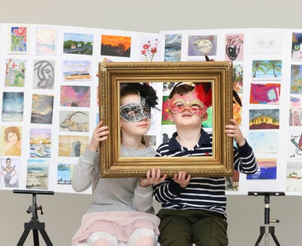 incognito 20243 image of two children holding picture frames