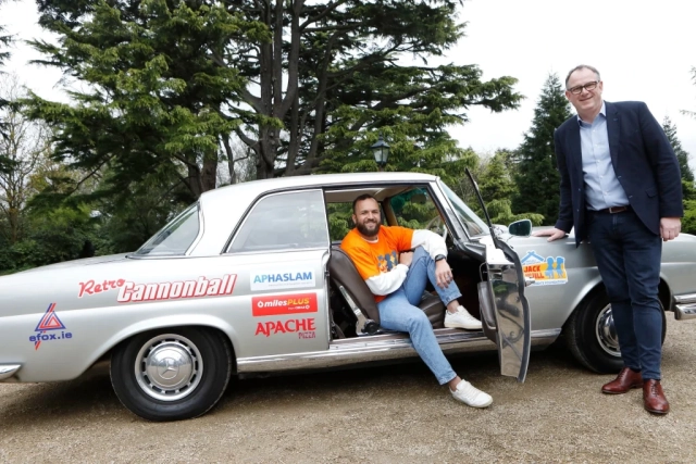 Rugby Gibson Park sitting in retro car for retro cannonball with Jack and Jill tee shirt on