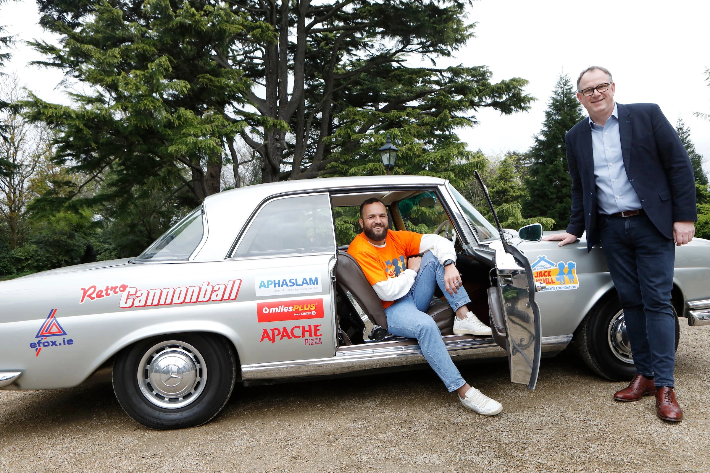 Rugby Gibson Park sitting in retro car for retro cannonball with Jack and Jill tee shirt on