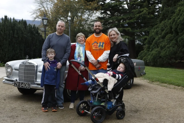 Jack and Jill family in front of retro car