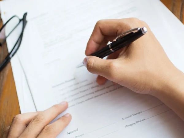 unrecognisable man filling out will form