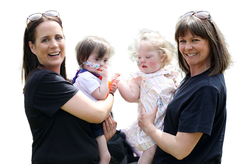 family-legacies-01 A photo of two Jack and Jill nurses smiling holding babies with feeding tubes