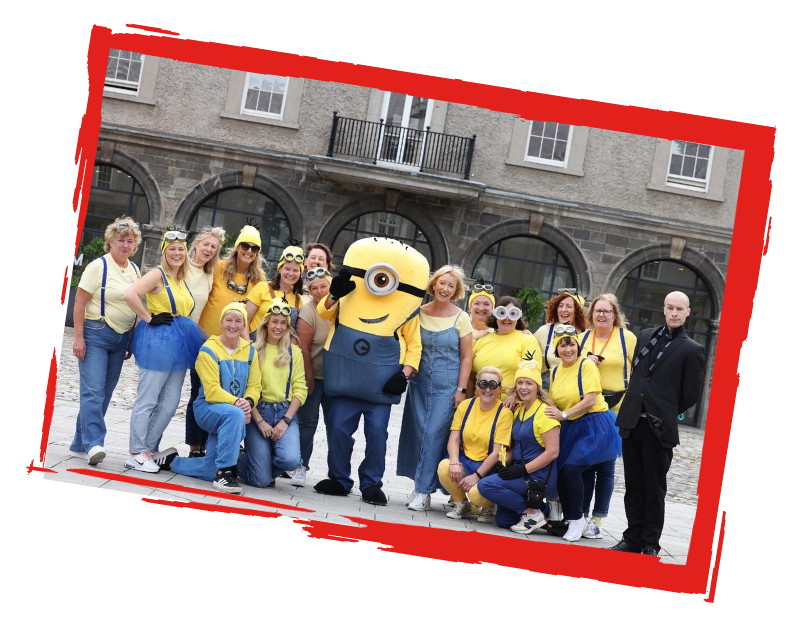 Jack and Jill team dressed in Minion-themed costumes posing outdoors with a Minion mascot and a person dressed as Gru.