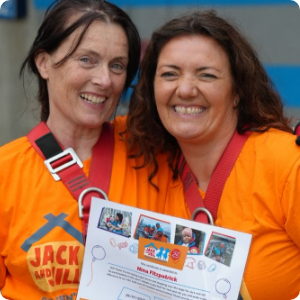 Jack and Jill fundraising supporters smiling together while holding an event certificate.
