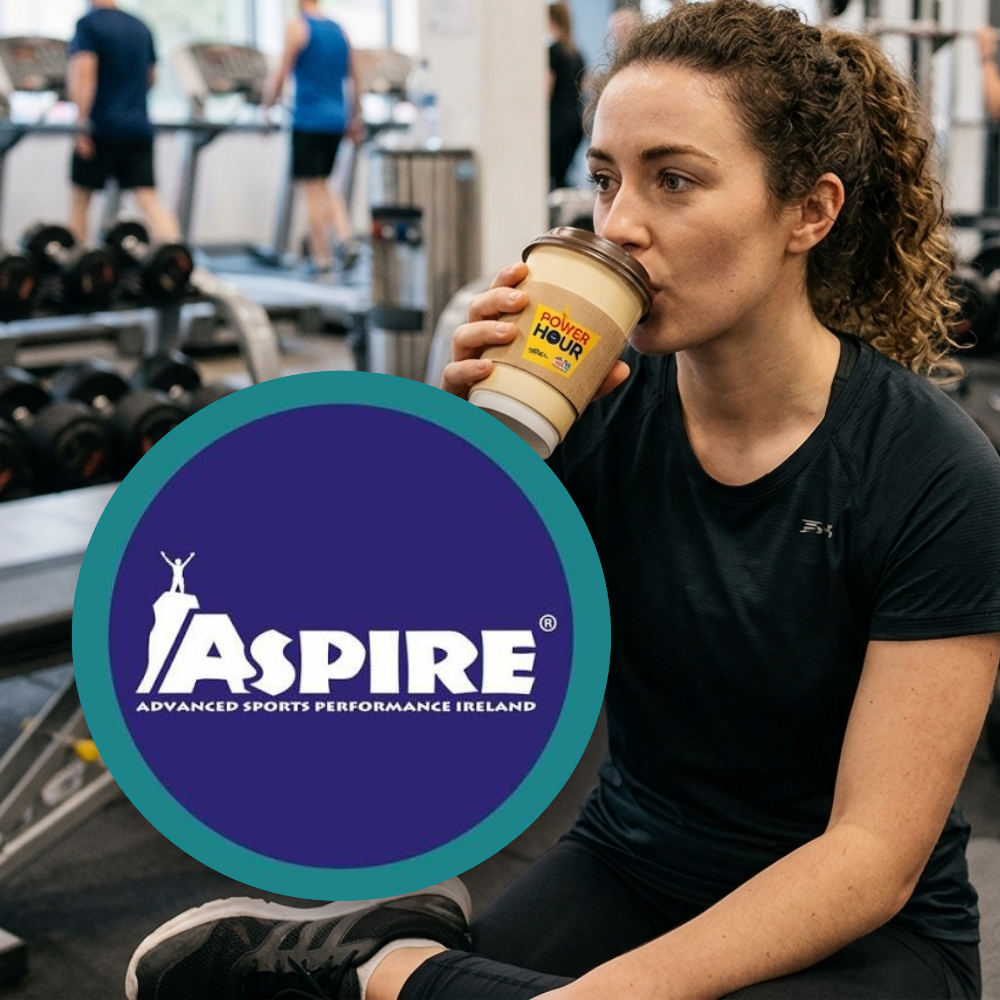 Aspire Performance A woman sitting in a gym drinking from a paper cup featuring a "Power Hour" logo, with a circular blue and turquoise overlay showing the "Aspire Advanced Sports Performance Ireland" logo.