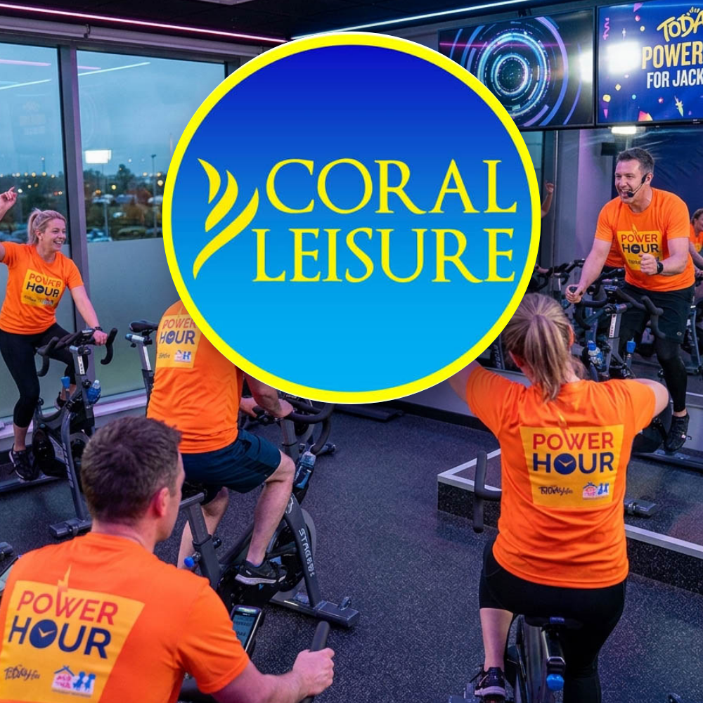Coral Leisure People in matching orange 'Power Hour' shirts participating in an indoor spinning or cycling class at Coral Leisure gym.