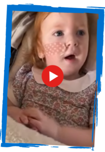 Video thumbnail featuring Chloë Feighery's little sister Heidi, with a red play button overlay.