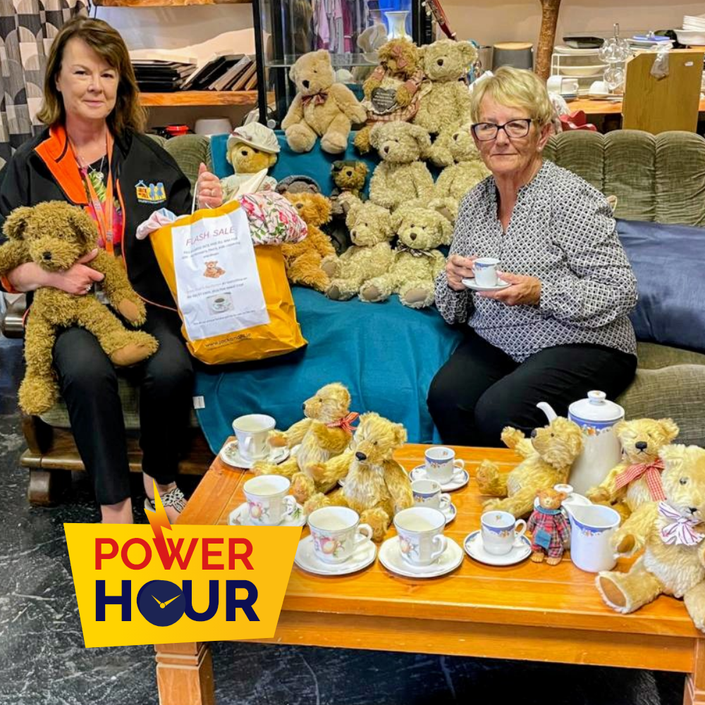 Power Hour Crookstown Two women seated on a sofa surrounded by teddy bears and teacups during a Power Hour charity event.