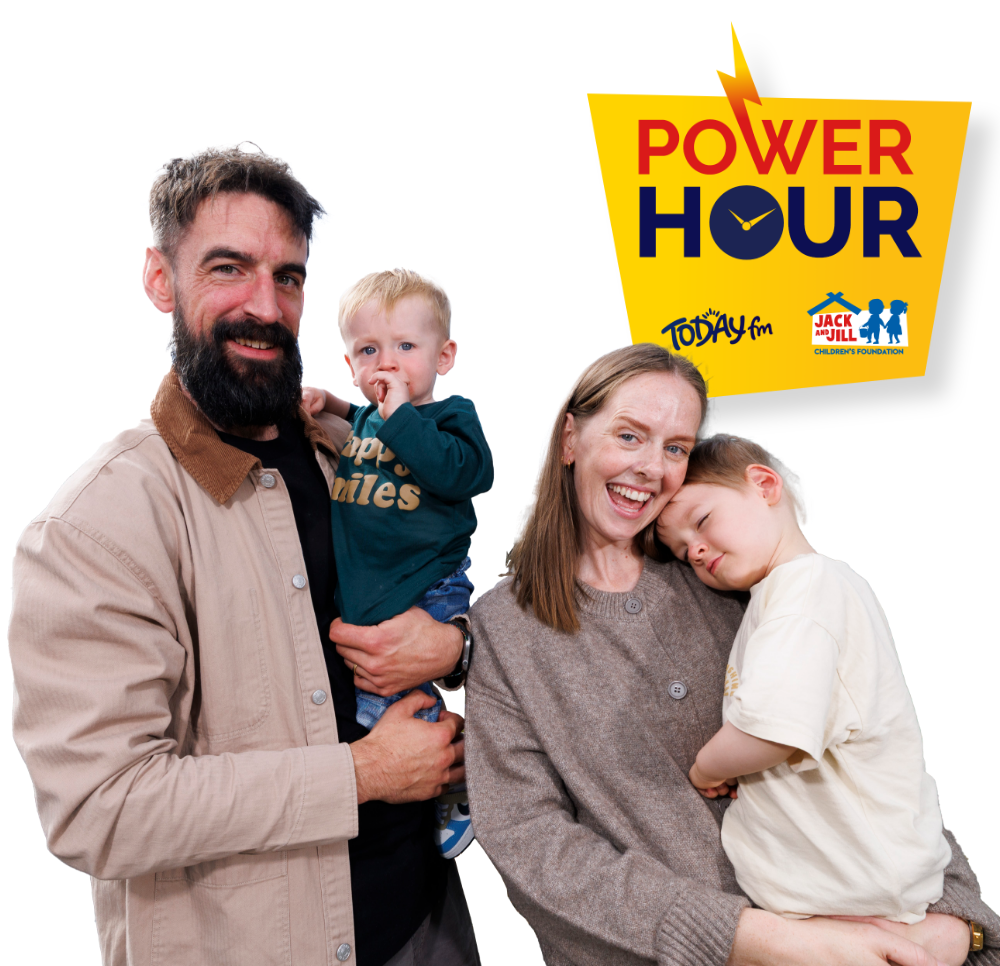 Power Hour Family – 2 Parents Charlotte and Kevin Ring stand with their children, Sonaí, 1, and three-year-old Seán Óg—a child supported by the Jack and Jill Children's Foundation—alongside the Today FM and Power Hour logo.