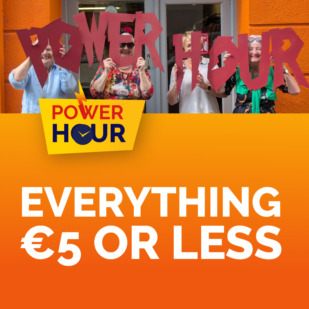 Power Hour Kilkenny Four smiling women holding large red cutout letters spelling POWER HOUR outside a shop, featured on an orange promotional graphic reading Power Hour: Everything €5 or Less.