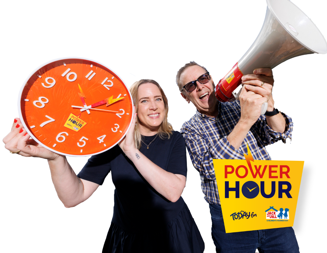 Today FM presenters posing with a large orange Power Hour clock and a red and white megaphone against a plain white background.