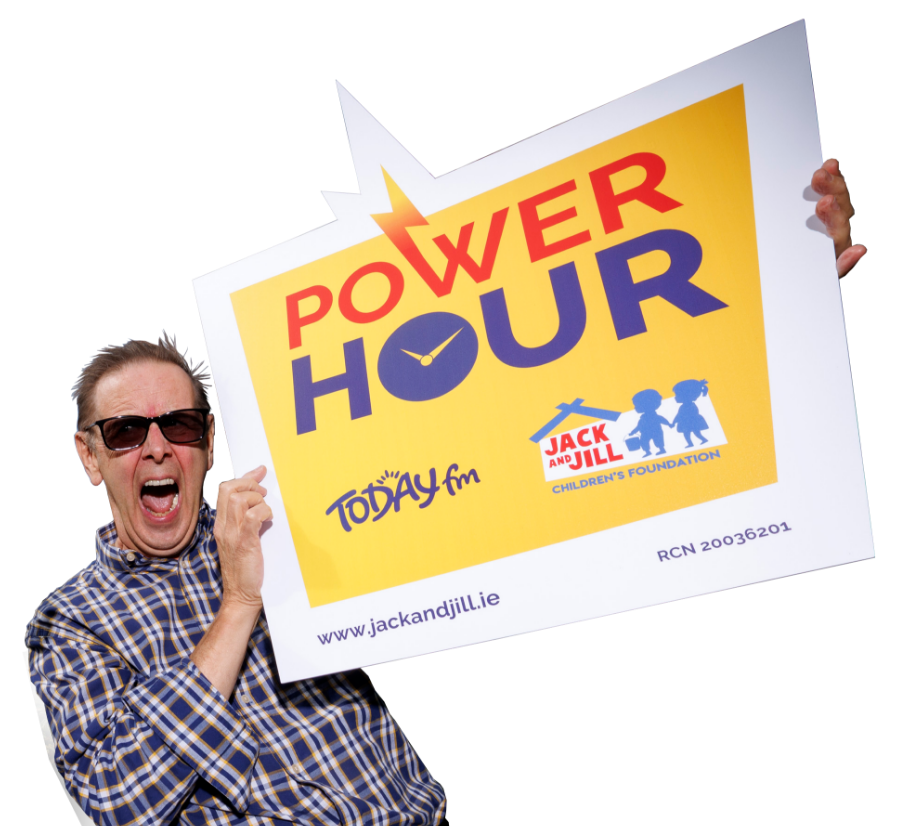 Power Hour today FM - 6264-0032 –Ian Dempsey Today FM presenter Ian Dempsey wears sunglasses and a plaid shirt, shouting enthusiastically while holding a large sign promoting the Power Hour for the Jack and Jill Children's Foundation.