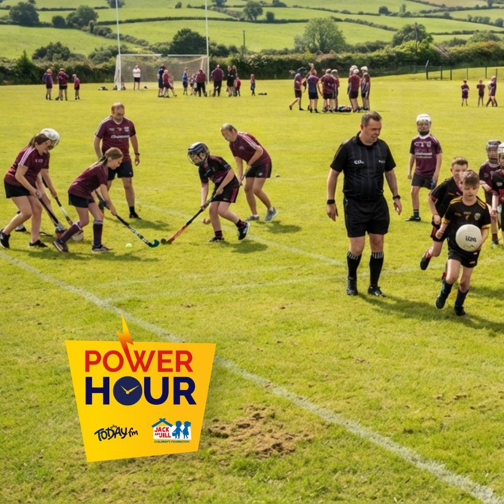 Renmore Community Centre Children and adults participating in outdoor sports and activities on a green pitch with the Power Hour campaign logo in the corner.
