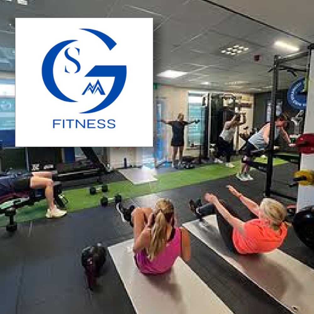 SMG Fitness People working out in a gym on mats and equipment, with an overlay in the upper-left displaying the blue logo for "SMG FITNESS".