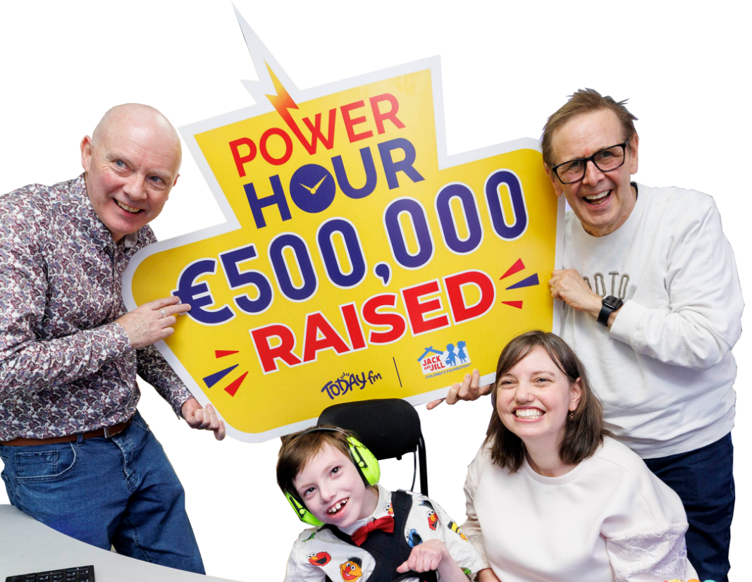 Ian Dempsey and the Garrahan family holding a Power Hour sign celebrating €500,000 raised for Jack and Jill.